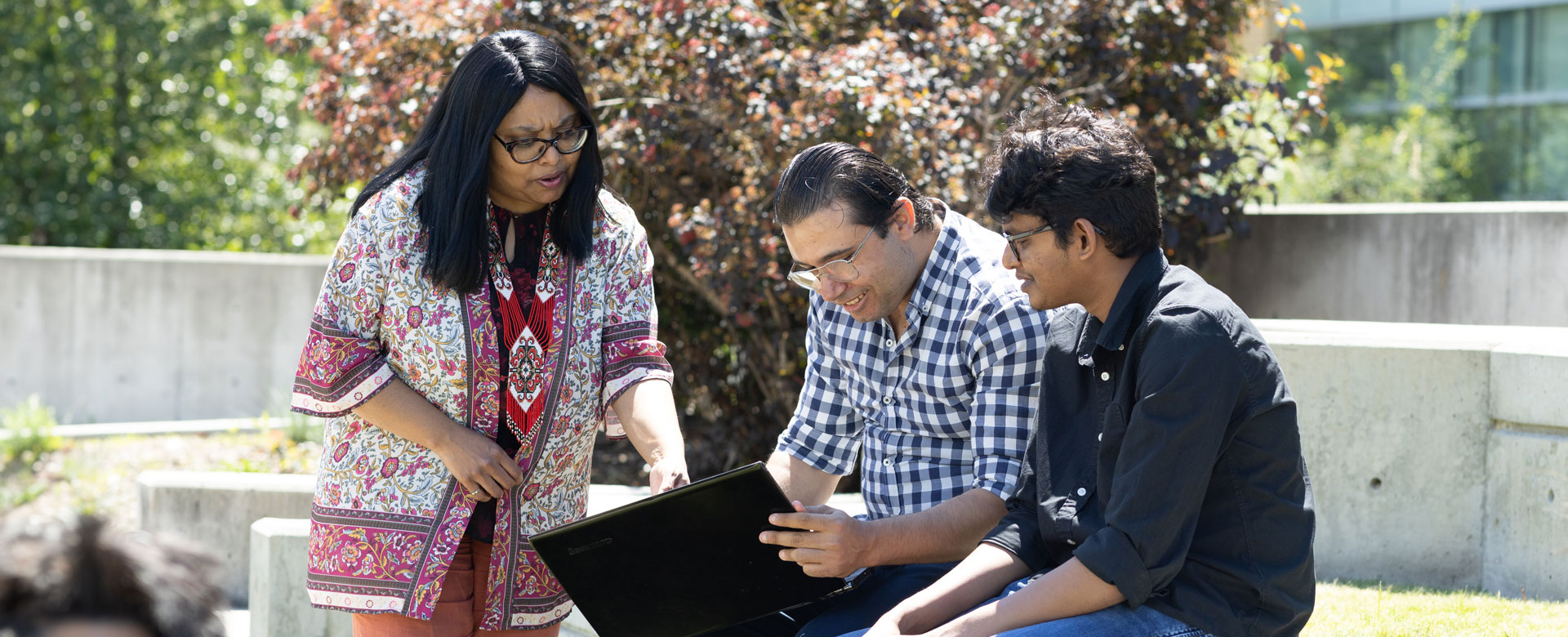 UBC Okanagan's School of Engineering's Sumi Suddiqua speaking with two individuals on campus.